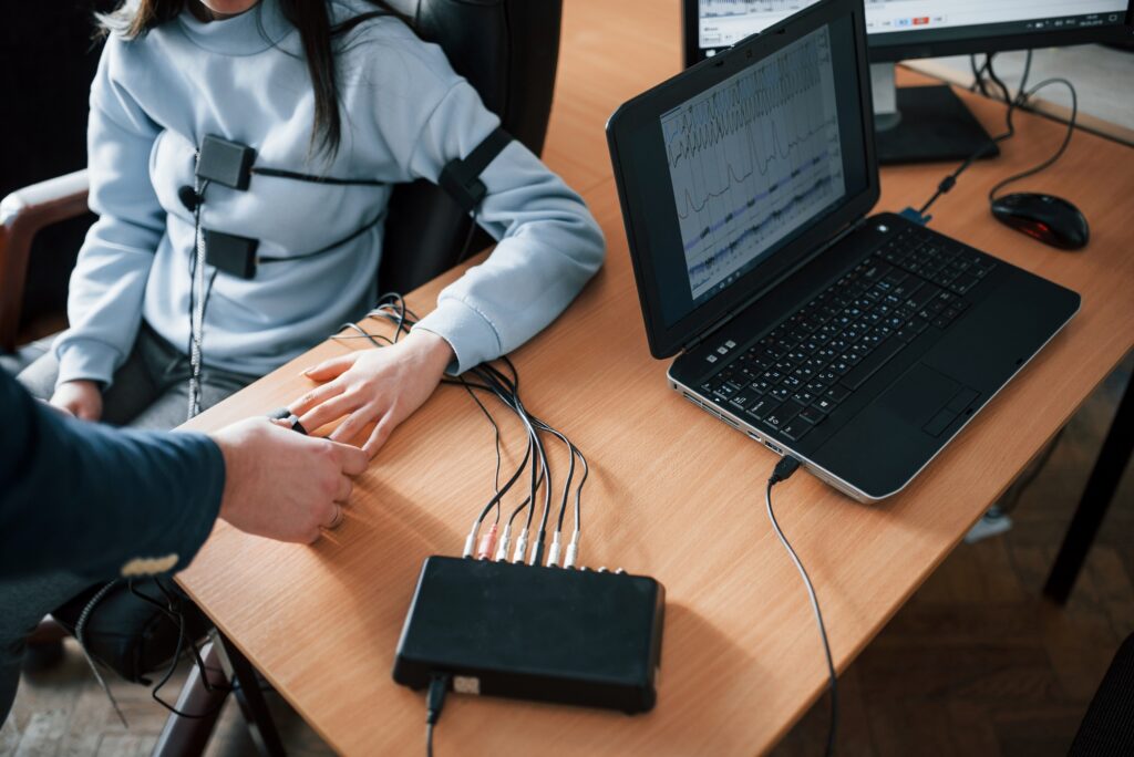 Woman completing polygraph test in office